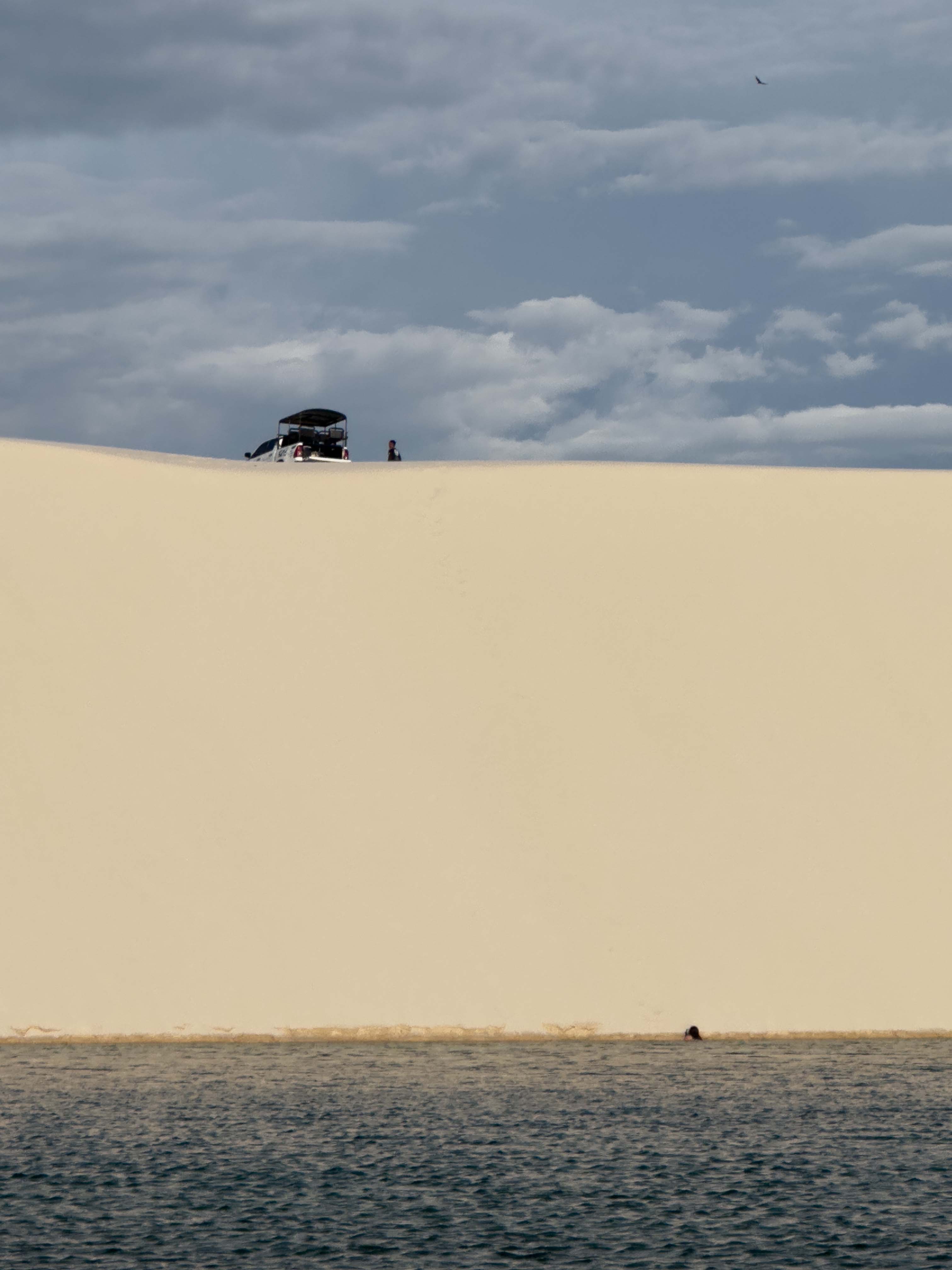 Our tour guide's truck on top of a sand dune with a lagoon below